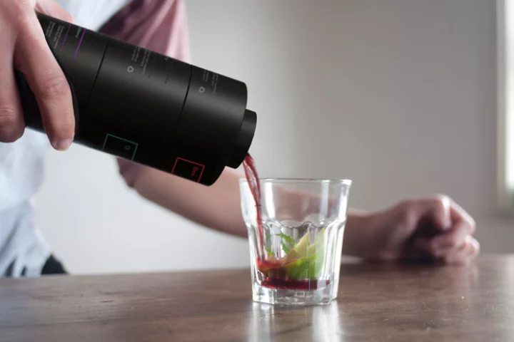 The finished cocktail being poured into a glass – after all of the elements have mixed together in the Enkaja modules