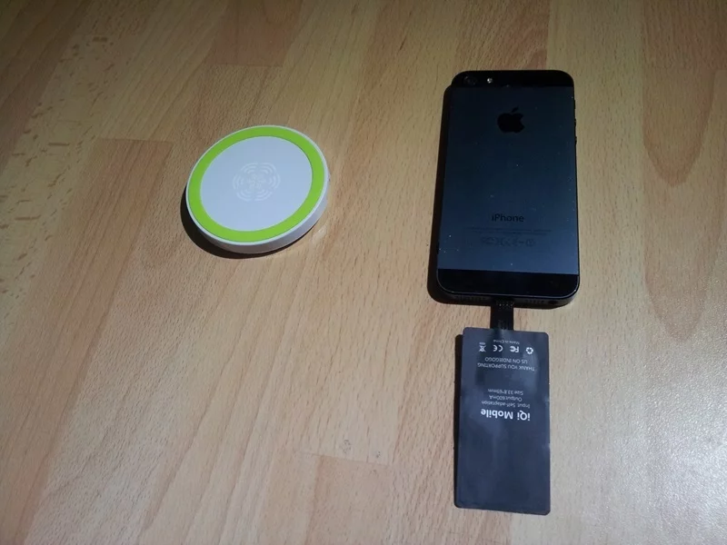 The iQi Mobile is attached to an iPhone's charging port