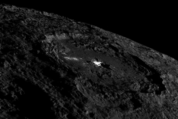 This view of the whole Occator crater shows the brightly colored pit in its center and the cryovolcanic dome