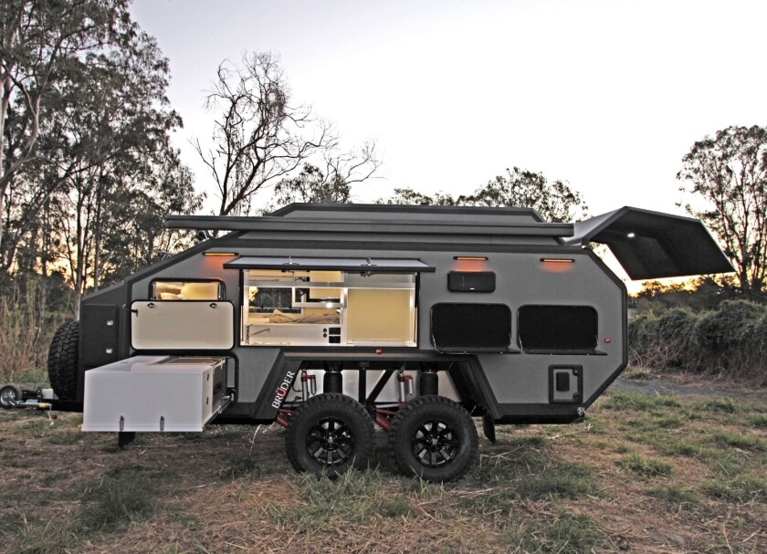 The side panel door provides access to the indoor/outdoor kitchen, while the slide-out completes the outdoor kitchen space with a fridge/freezer, worktop and storage