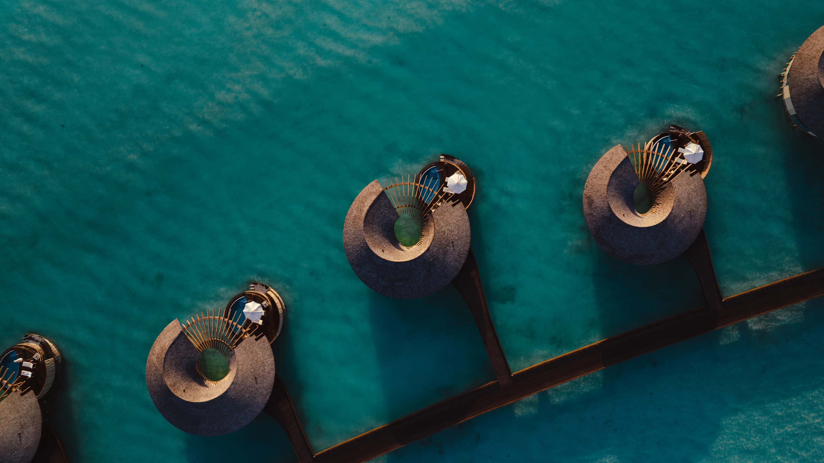Helical structures emerge from the sea, providing guests with stunning views across the water