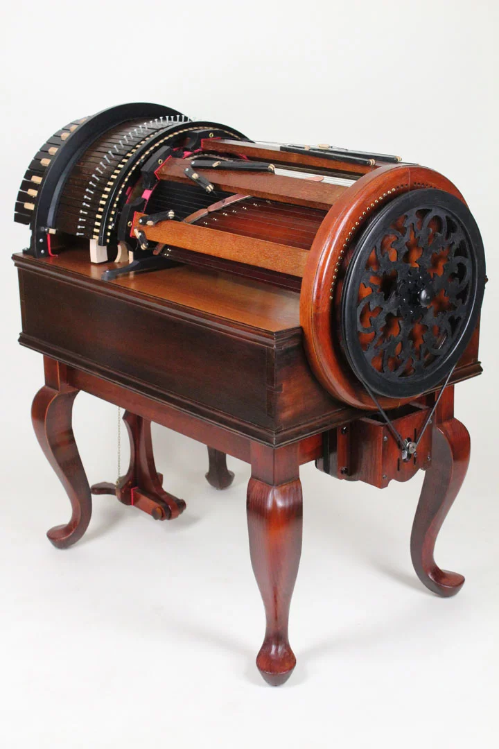 At the press of a key, the instrument's patent-pending action moves the respective string toward a rotating, rosin-edged wheel spinning inside the barrel of the Wheelharp