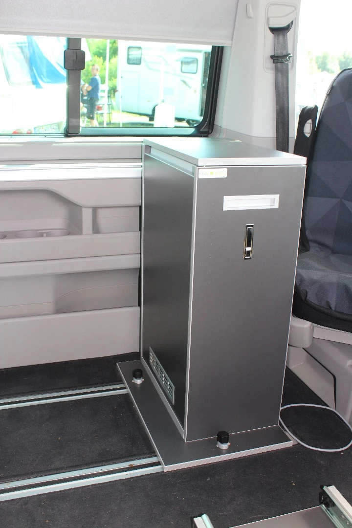 The Santa Cruz series of Bus Boxxes features a fridge box and kitchen that sit in front of the three-seat bench. The kitchen can slide out the door for outside cooking