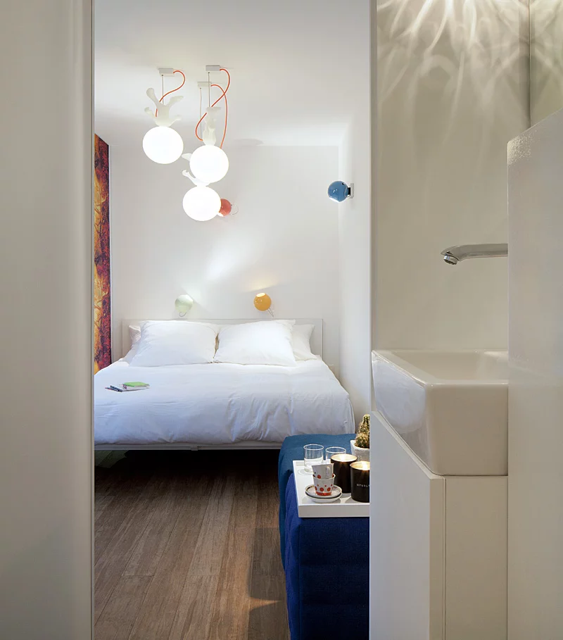 Each 20-foot long guest room has enough space for a floating box-spring bed, iPod docking station, air conditioning, and a bathroom area with a toilet and rain shower