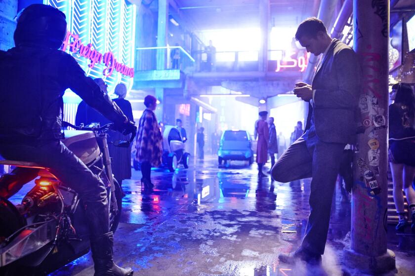 The wet, neon-covered city streets directly recall Blade Runner in Duncan Jones' upcoming Mute