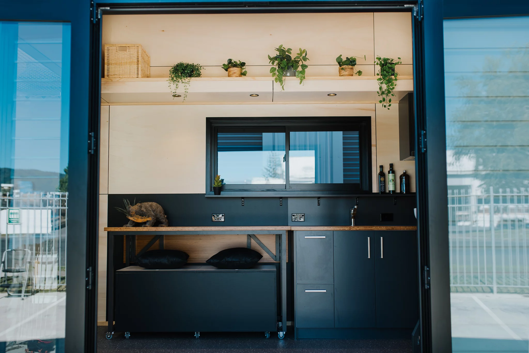 The Tiny Tāwharau's large doors open the home up to the outside