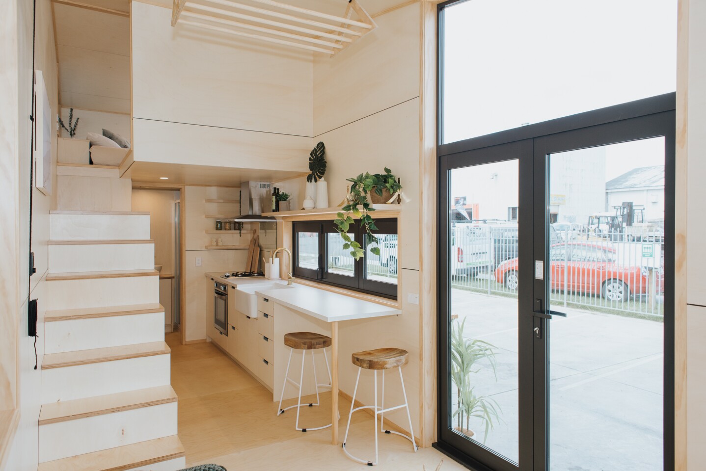 The Hilltop Tiny House is accessed by double glass doors