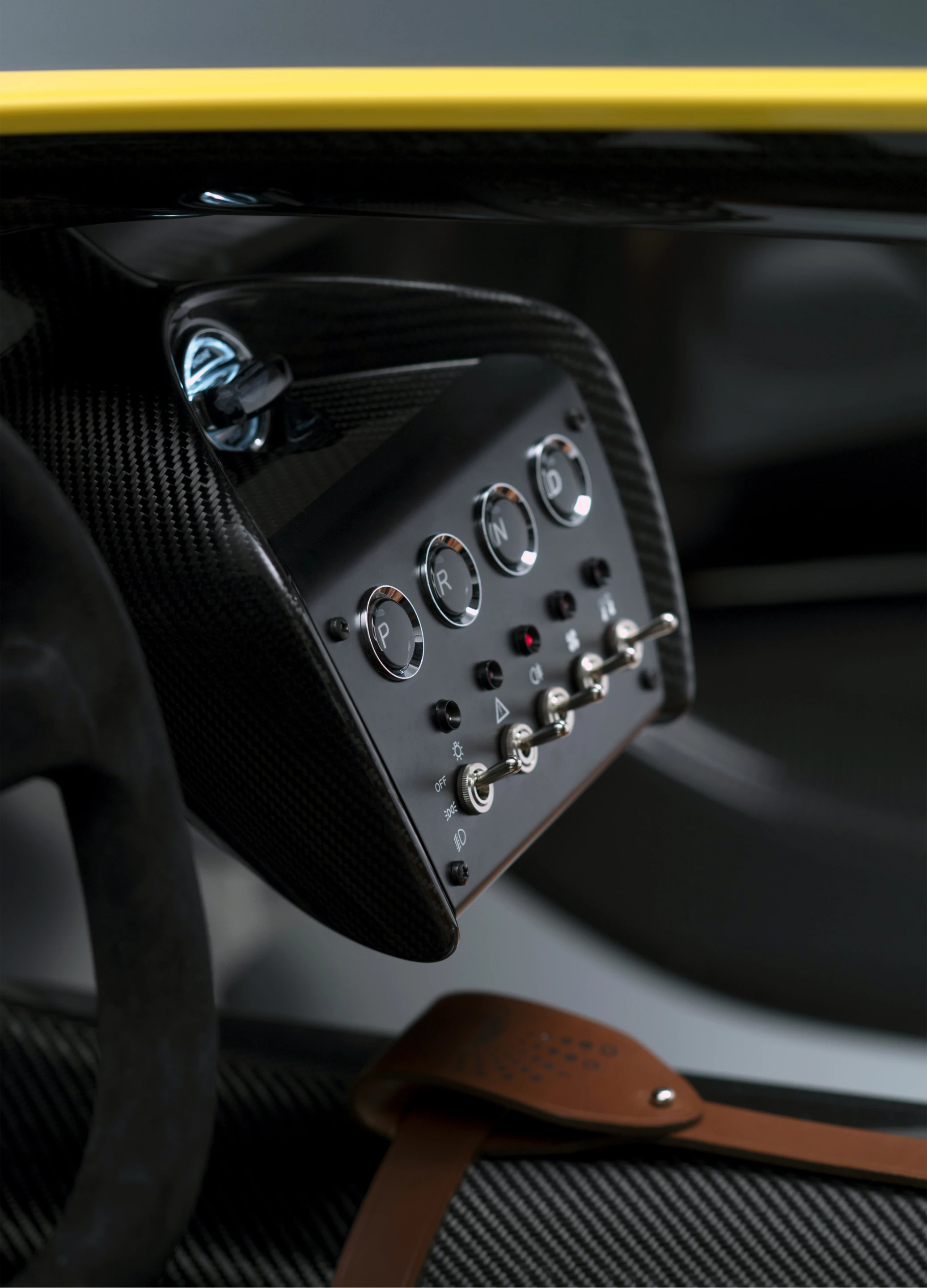 Old school toggle switches contrast nicely under Aston's typical push-button shifter panel