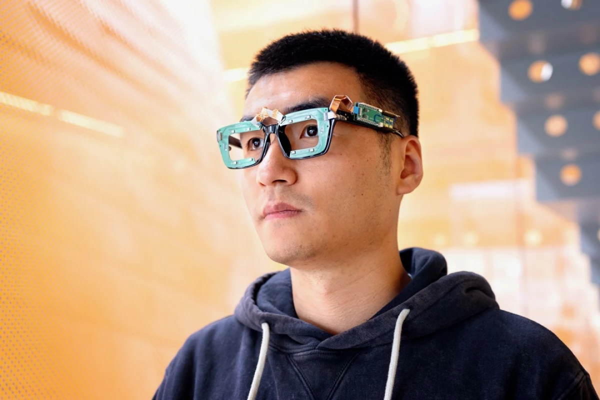 Head scientist Ke Li models prototype glasses equipped with both the GazeTrak and EyeEcho systems