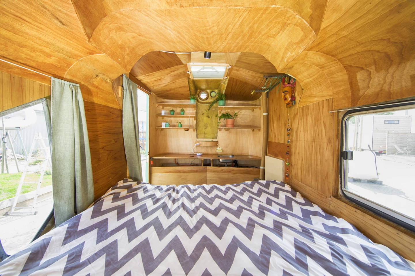 Little Pea's interior is lined with wood and includes a double bed and some storage space