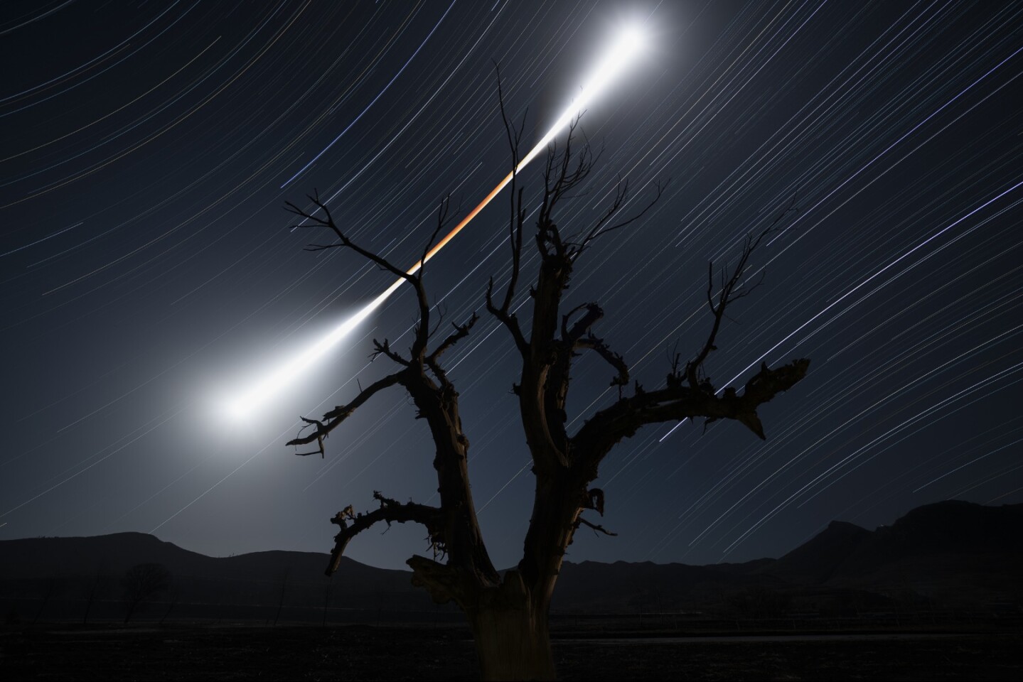 Runner-Up in Skyscapes. On 31 January 2018, a spectacular total lunar eclipse occurred. The photographer set his camera for a four-hour stack exposure and after he took about one thousand images, he finally captured an image that reflects the changes of the Moon's colour and brightness before, during and after the eclipse