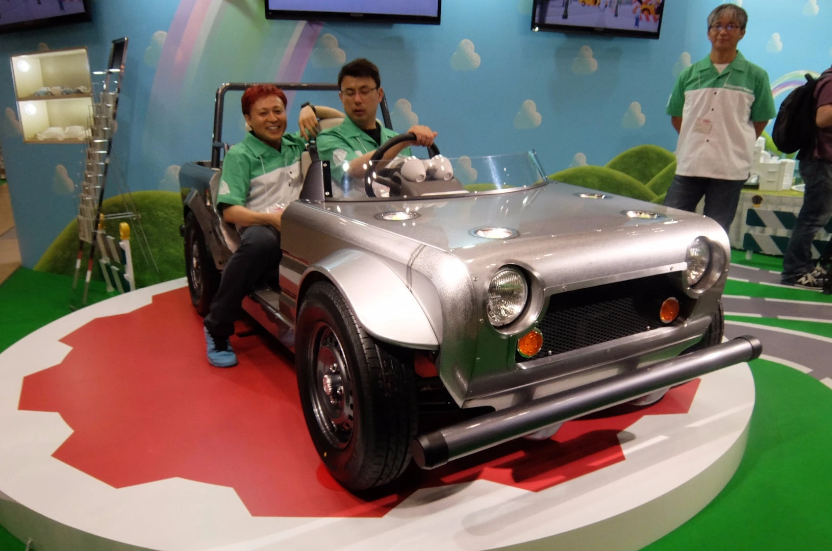 Kenji Tsuji (project member) driving and sitting to his right Kota Nezu (vehicle designer) share a vision of the future for car design