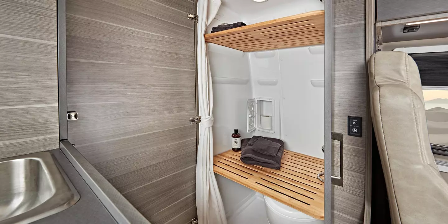 Removable bamboo shelves make the wet bath a closet or drying room when not in use as a bathroom