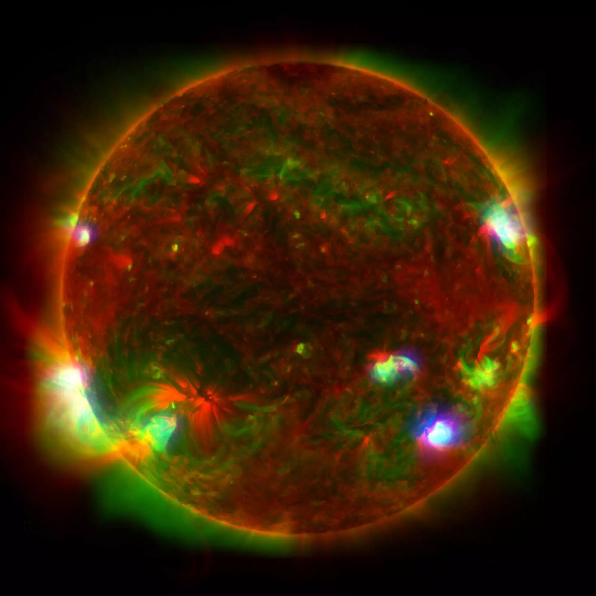 An unusual view of the Sun, compiled by stacking images from three very different instruments: high-energy X-rays from NuSTAR (blue), lower-energy X-rays from the X-ray Telescope (green), and ultraviolet from the Solar Dynamics Observatory (red)