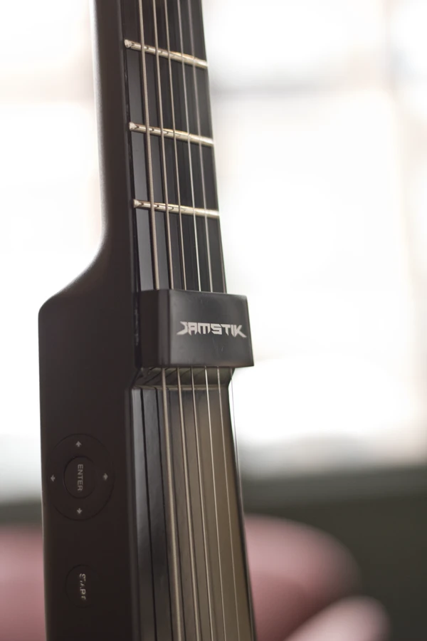 The compact digital guitar features a system for detecting when a string has been picked