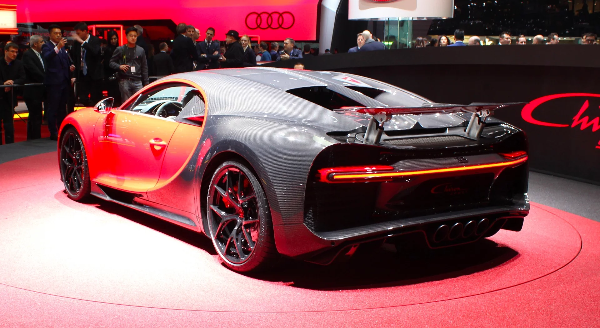 Up close, the carbon fiber treatments to the aero wing, diffuser, etc. can be noted on the Bugatti Chiron Sport. A lightweighted exhaust deflector can also be seen