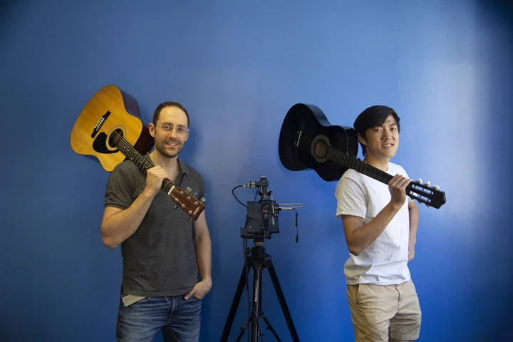 Researchers Mark Sheinin (left) and Dorian Chan with their remarkable optical microphone, which is capable of constructing a high-fidelity sound signal from single instruments playing in groups