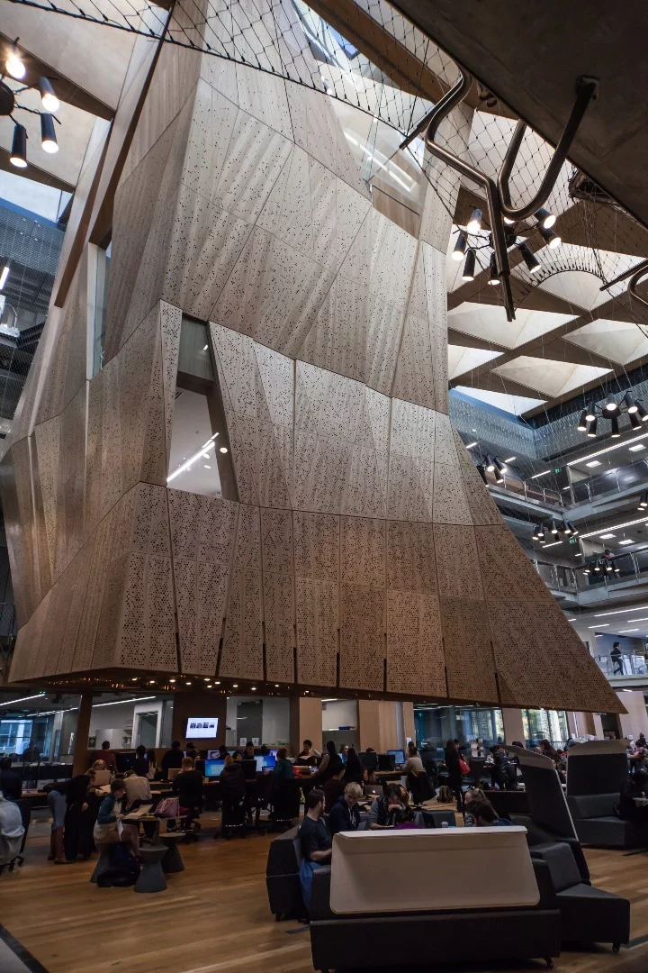 The building's centerpiece is a stalactite-like structure that houses three studio spaces stacked on top of one another