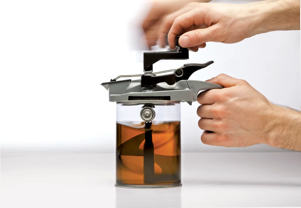 The Mixing Mate attaches to a paint can to easily stir paint, pour it out smoothly, and even seal it for later