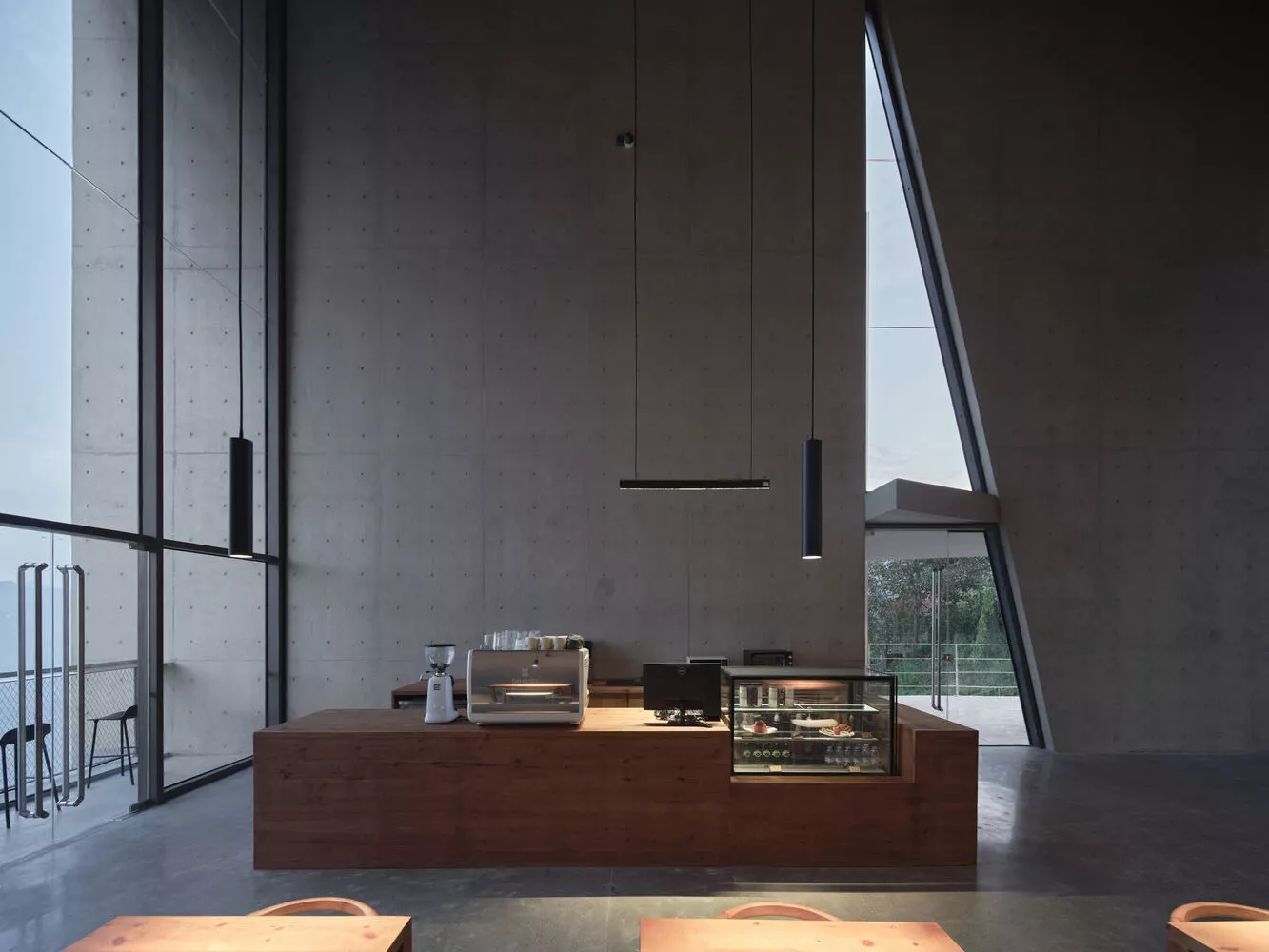 The top level features a café under a sloped roof, fostering a bright, open atmosphere