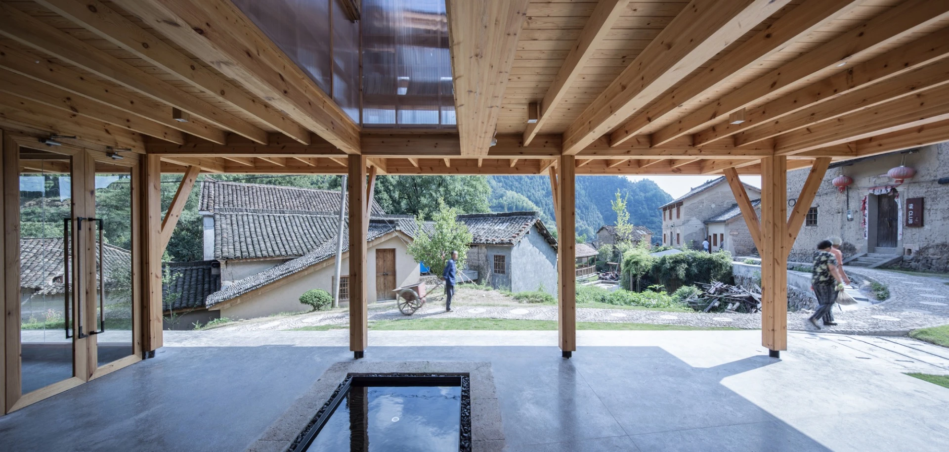 The Mountain House in Mist is centered around a patio area with a rain-fed water feature