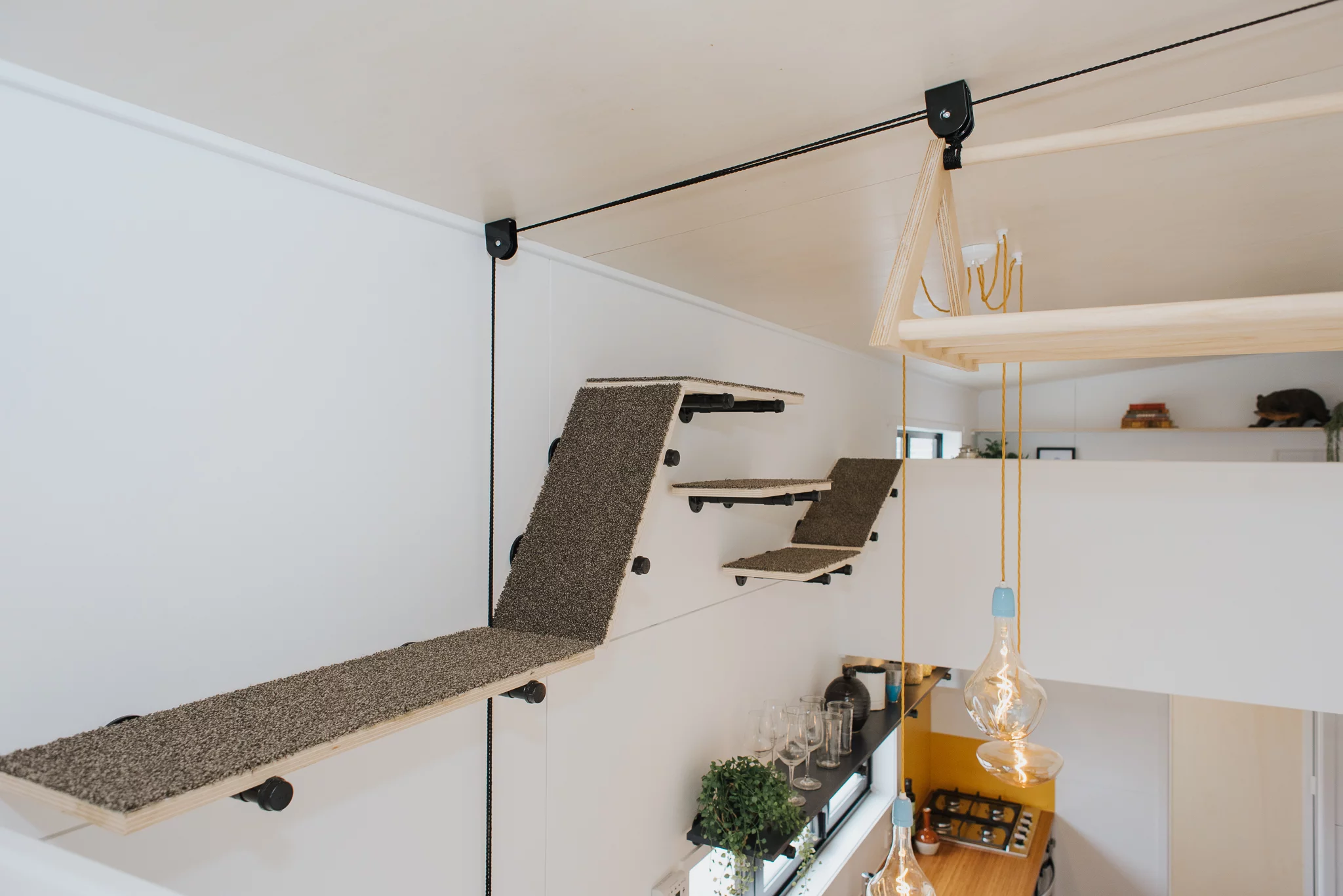 Cyril the Tiny House has a cat walkway that offers the felines (relatively) easy access between the home's two lofts. The pulley system is not for cat transport, but for drying clothes (though the resident cats may think otherwise)