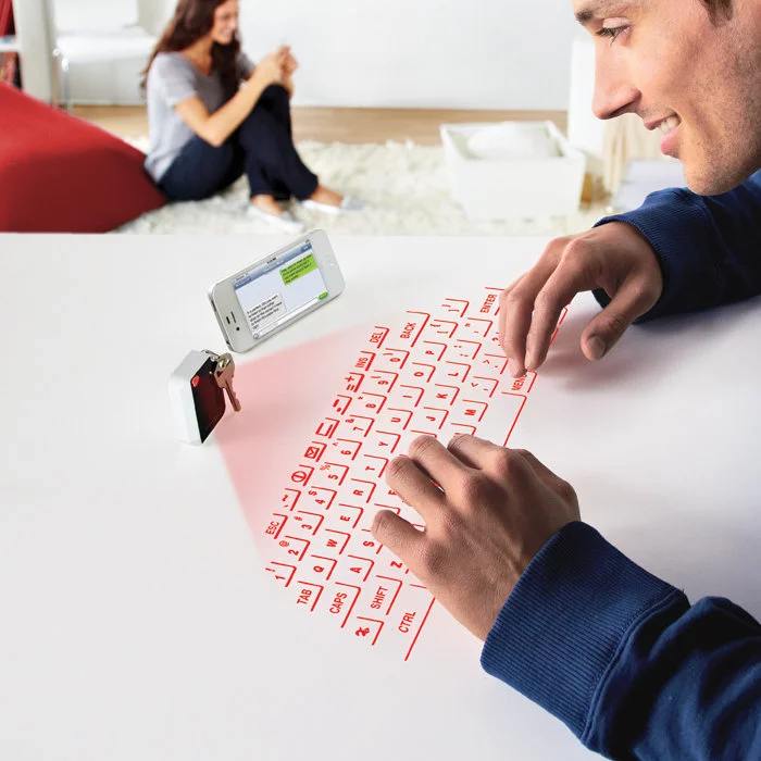 CTX's Virtual Keyboard projects a usable laser outline of a QWERTY keyboard onto any flat surface while fitting inside a small keychain