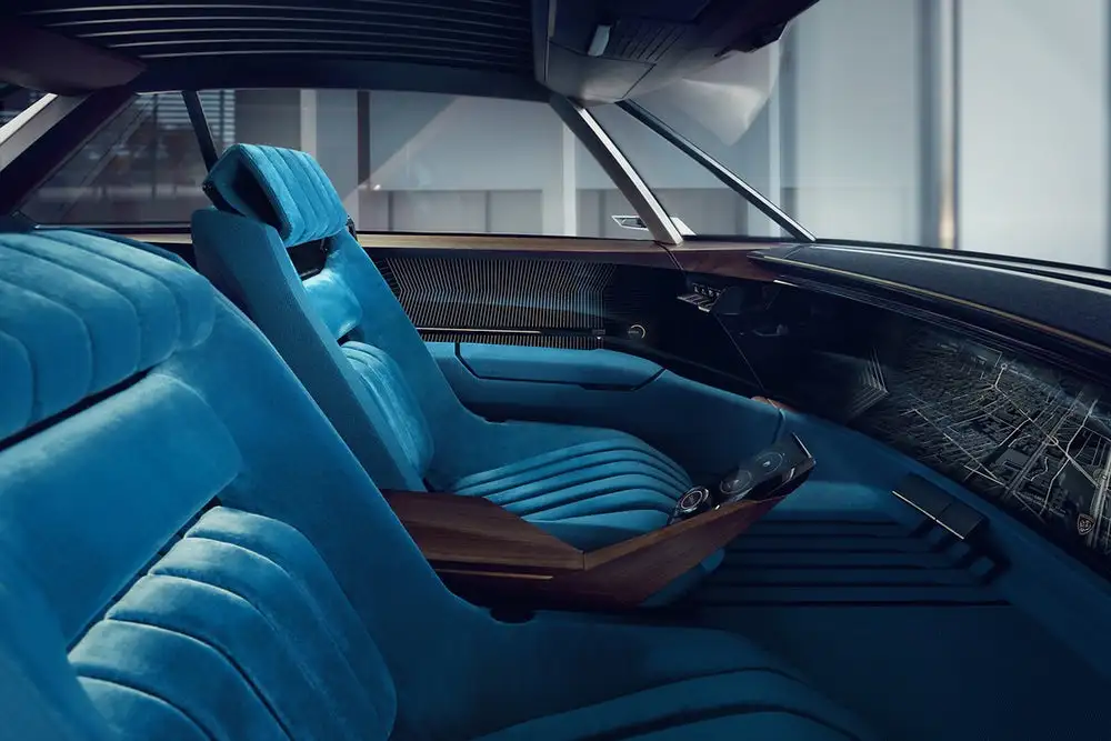 Shown here with its steering wheel retracted, the Peugeot e-Legend features two human drive modes and two autonomous modes