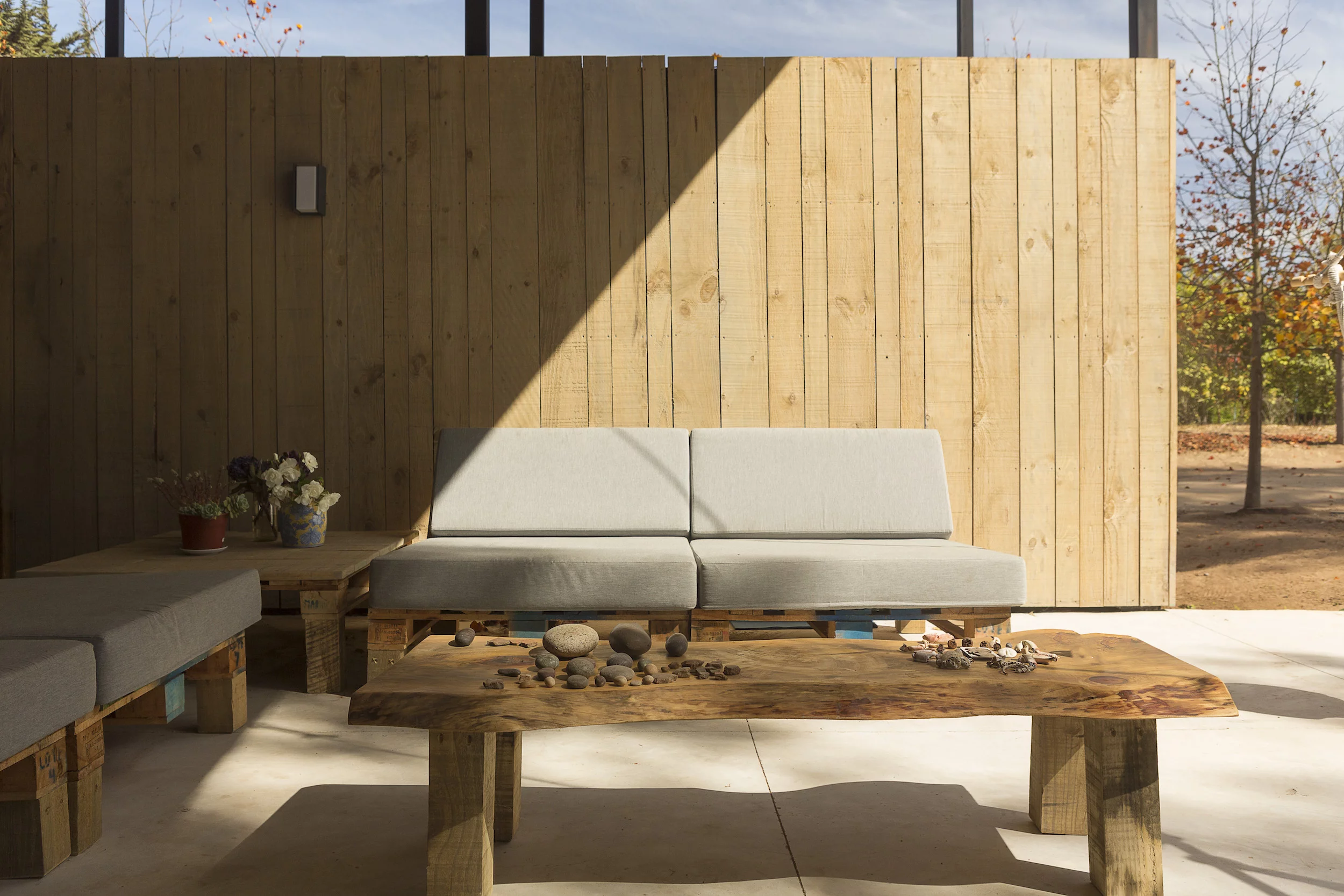 Container House's semi-outdoor area has seating that's made from old wooden pallets used to transport fruit