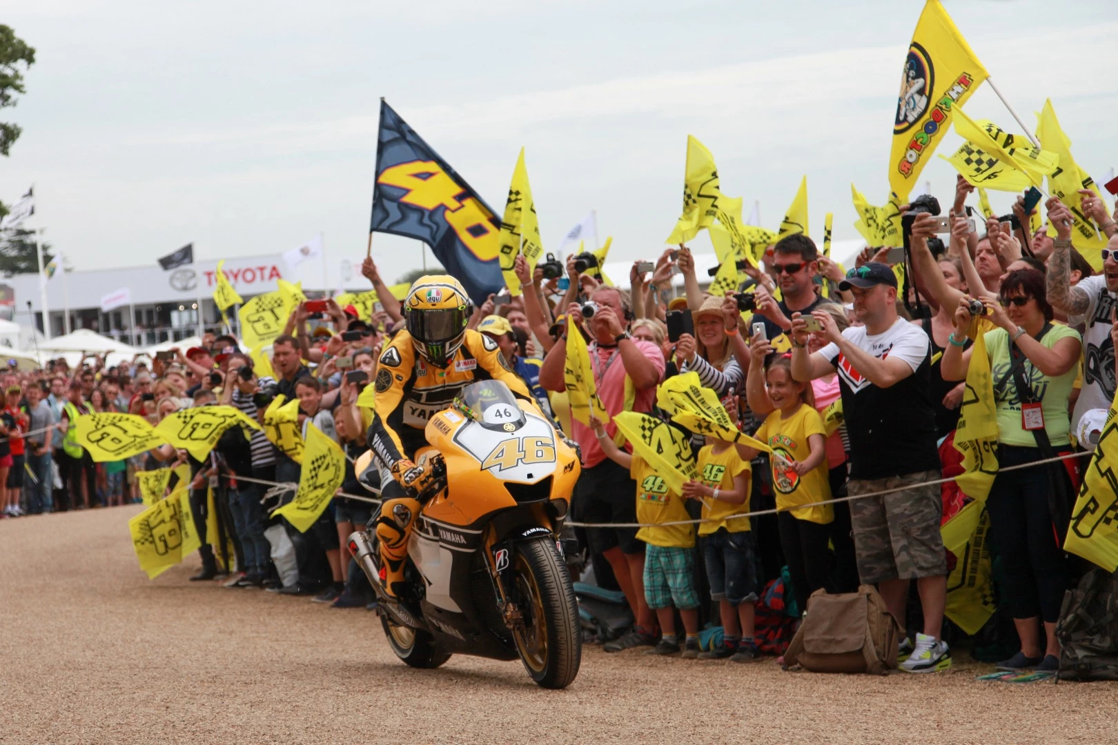 Valentino Rossi gets a tumultuous reception from the Goodwood crowd as he rides his YZR-M1 MotoGP bike to the start line.