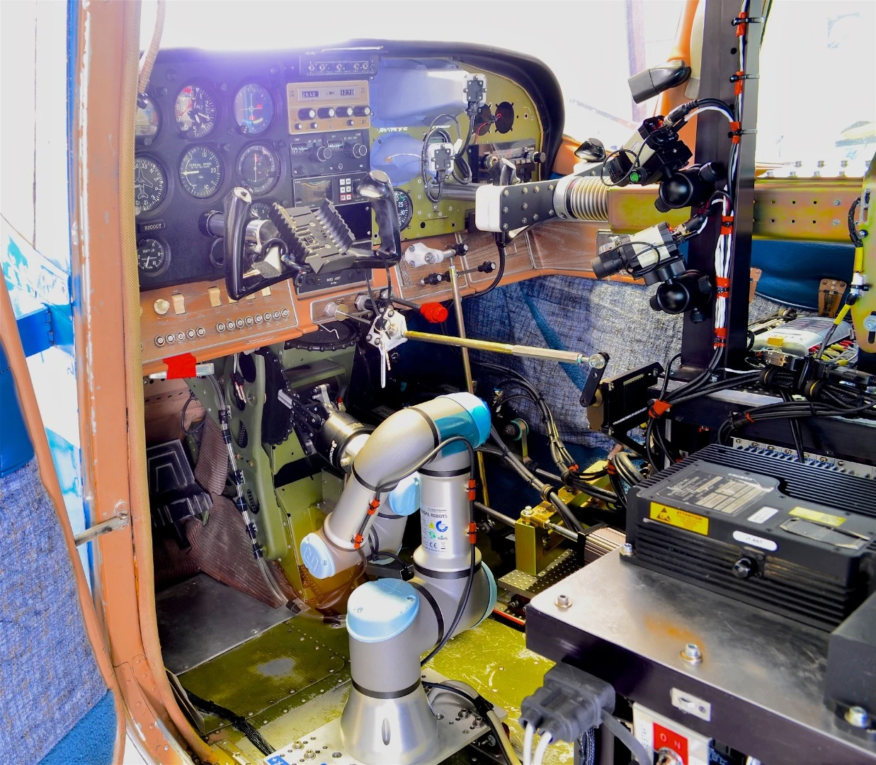 A cockpit view of ROBOpilot attached to seat rails with no permanent modifications to the aircraft