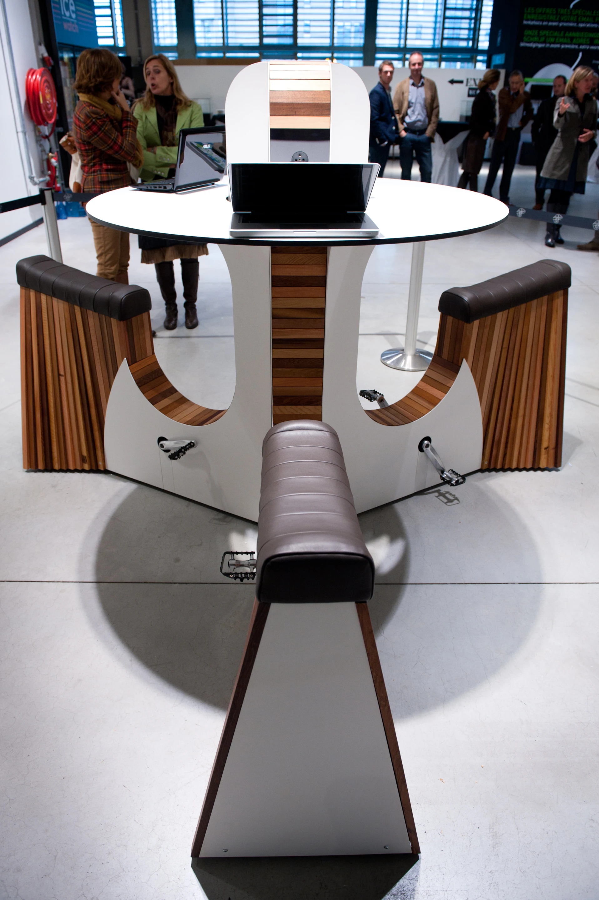 The standard WeBike arrangement consists of three seats around a circular table, each with its own set of pedals that convert gentle cycling action into electricity