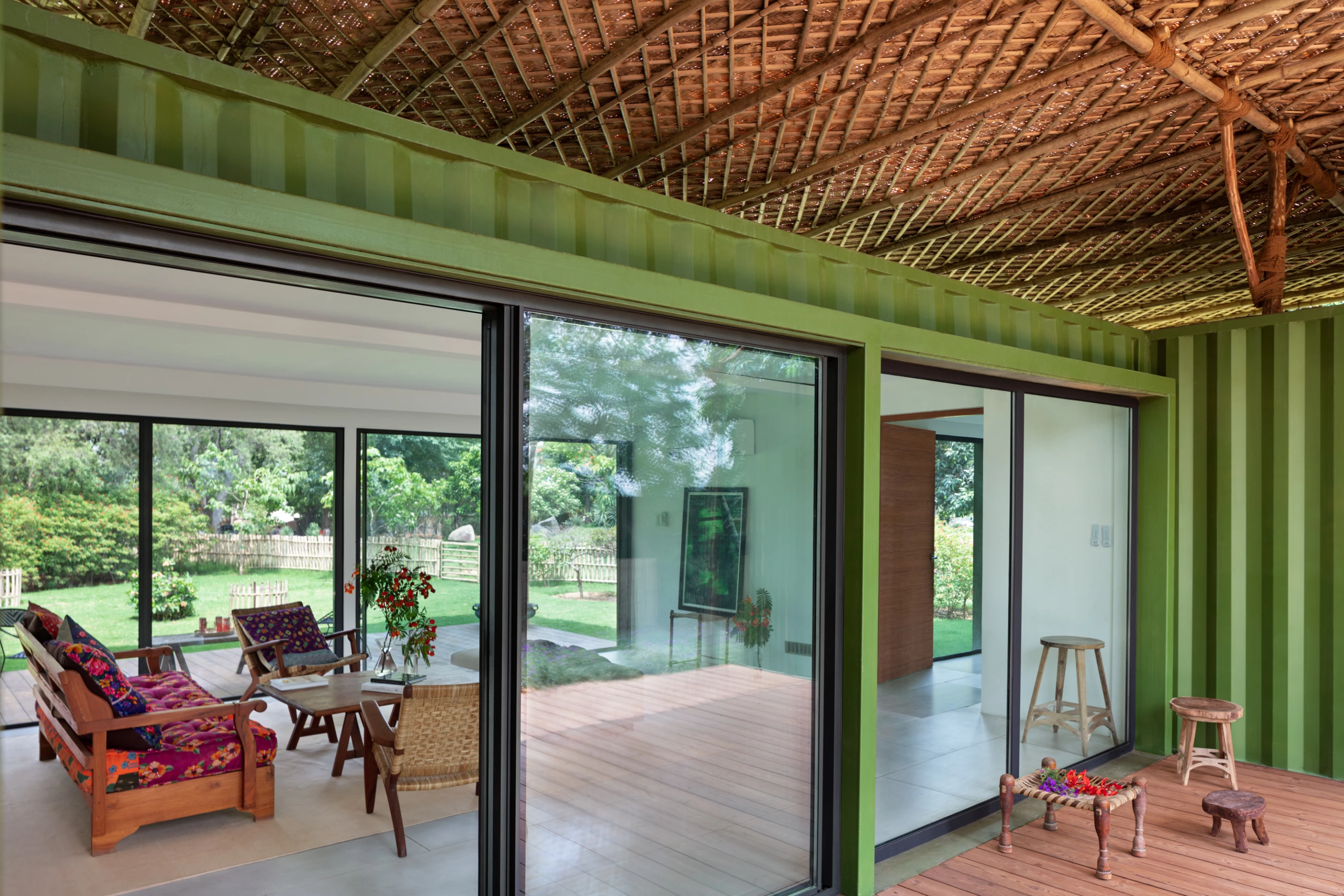 The shipping container homes have been heavily modified with generous glazing and can be opened up to the outside to maximize natural ventilation