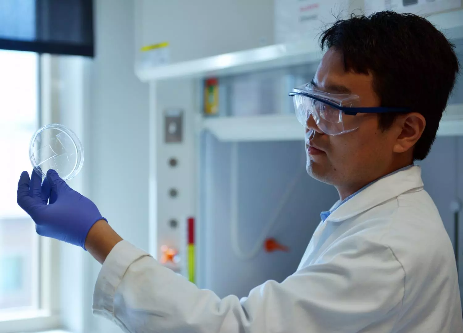 Researcher Qingkun Liu holds up samples of the new transparent aerogel, which could make windows better insulators