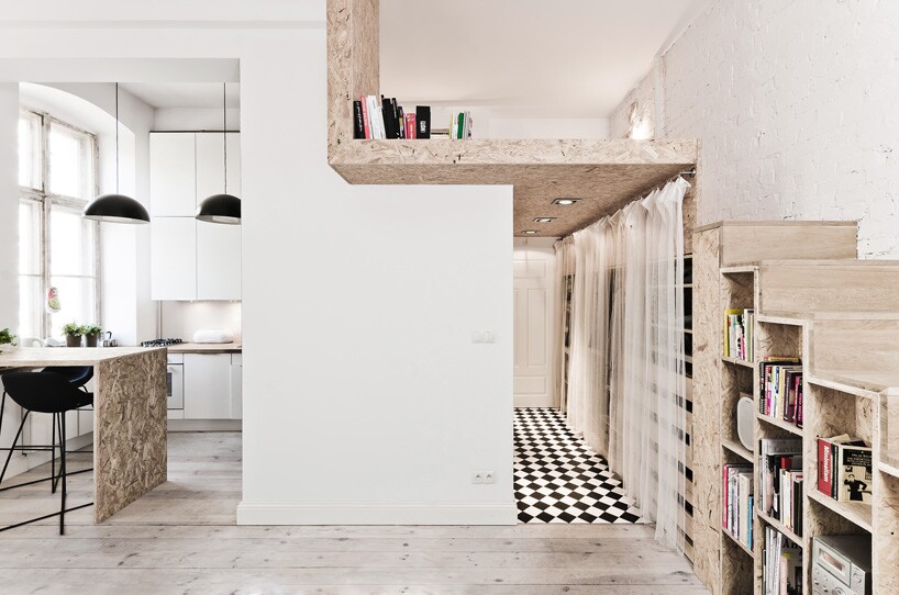 The designers fitted a bed area over a wardrobe, accessible via a small wooden staircase