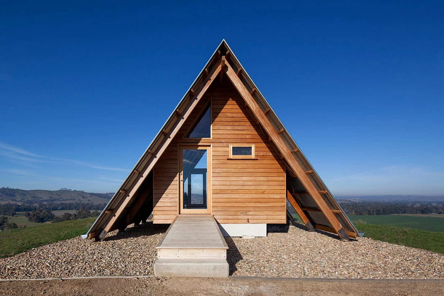 Inside the solar-powered JR's Hut is a bed for two, bathroom with a view and freestanding wood burner fireplace
