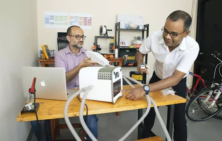 Ahad Syed (left) and Dr. Adnan Qamar, working on the Ventibag system in Qamar's garage