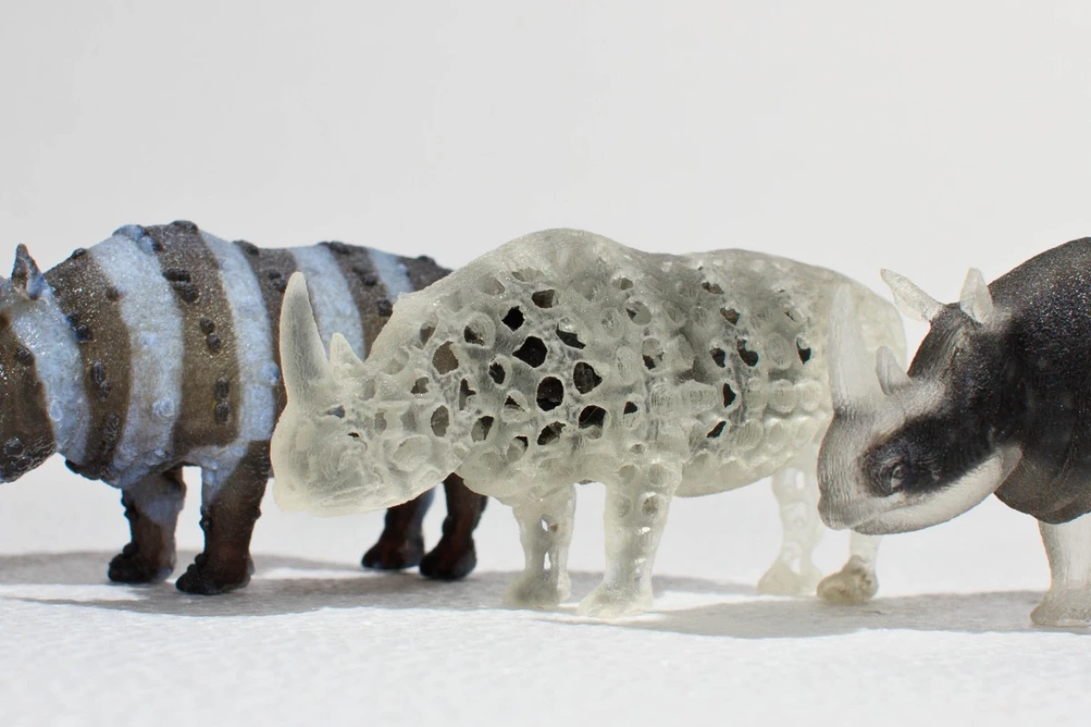 A zebra-like textured rhino with spiky skin, a porous rhino and an opaque rhino with a transparent shell 3D printed with a multi-material printer (Photo: MIT Computational Fabrication Group)