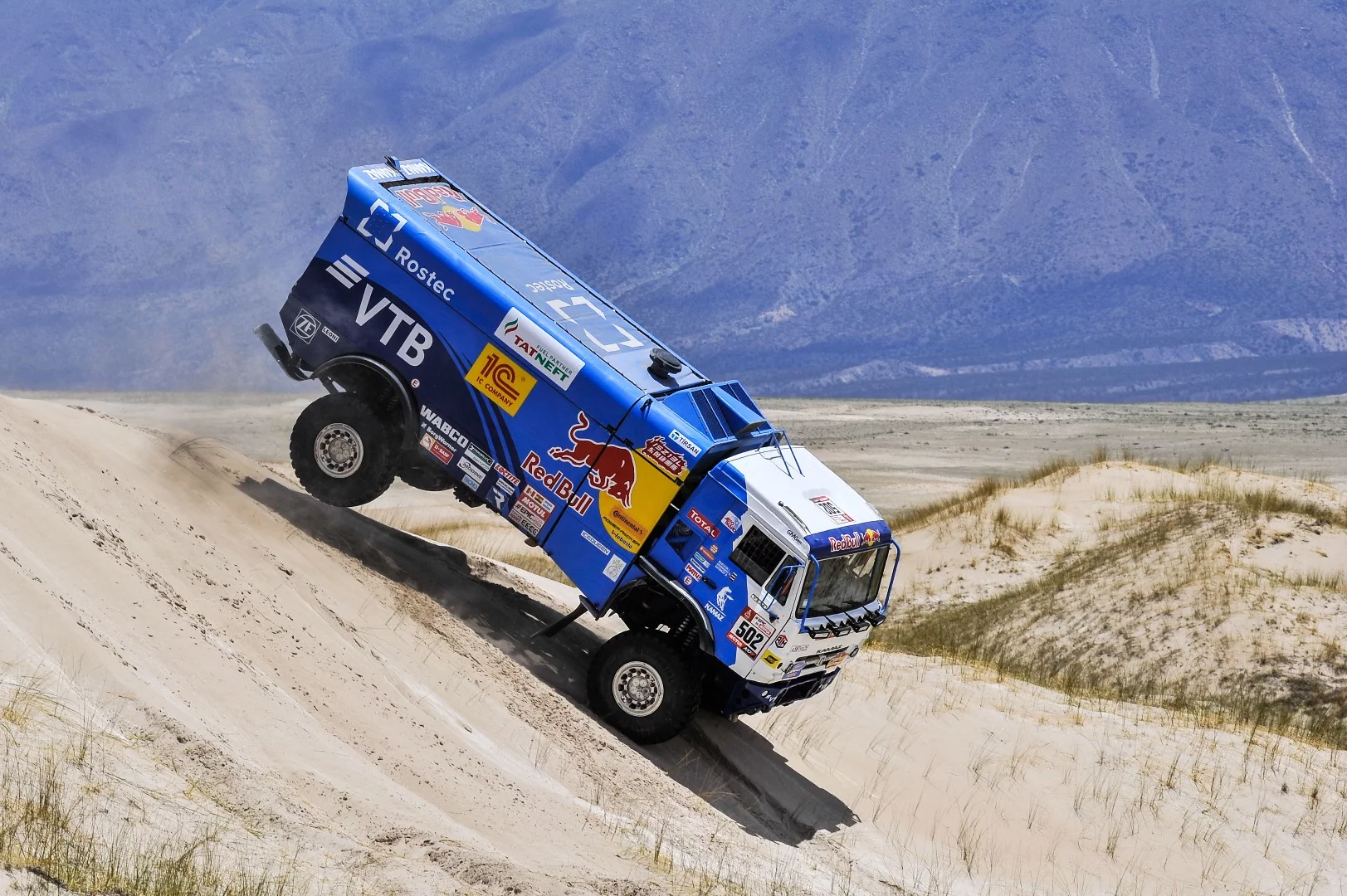 Hard work, all the time. Dimitry Sotnikov, Ruslan Akhmadeev and Ilnur Mustafin find their Kamaz truck at a confronting angle during Stage 10