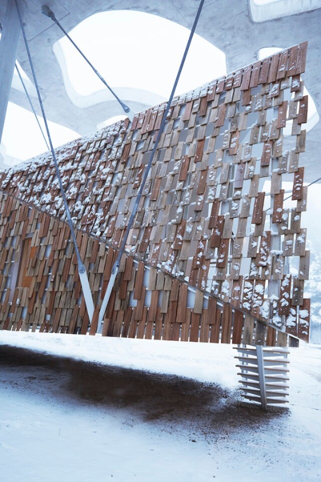 The dwelling features a natural timber facade, made from a series of locally sourced oak and larch panels