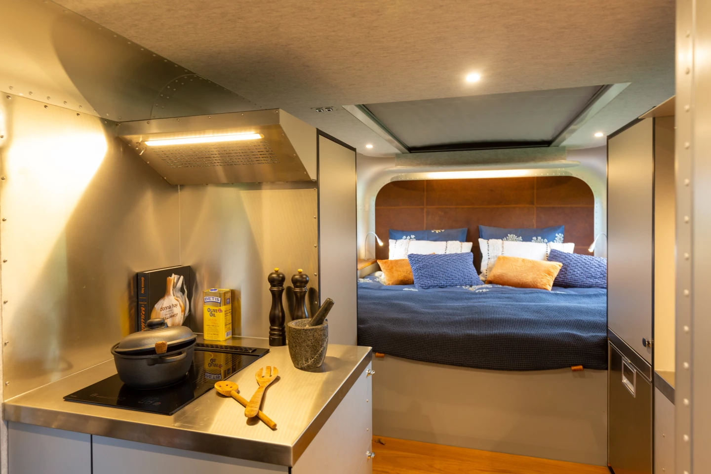 The indoor kitchen includes a three-burner stove, sink and fridge/freezer