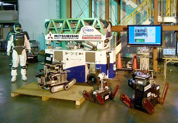 The MHI-Super Giraffe (background) along with other robots developed specifically for the clean up of TEPCO's Fukushima nuclear plant