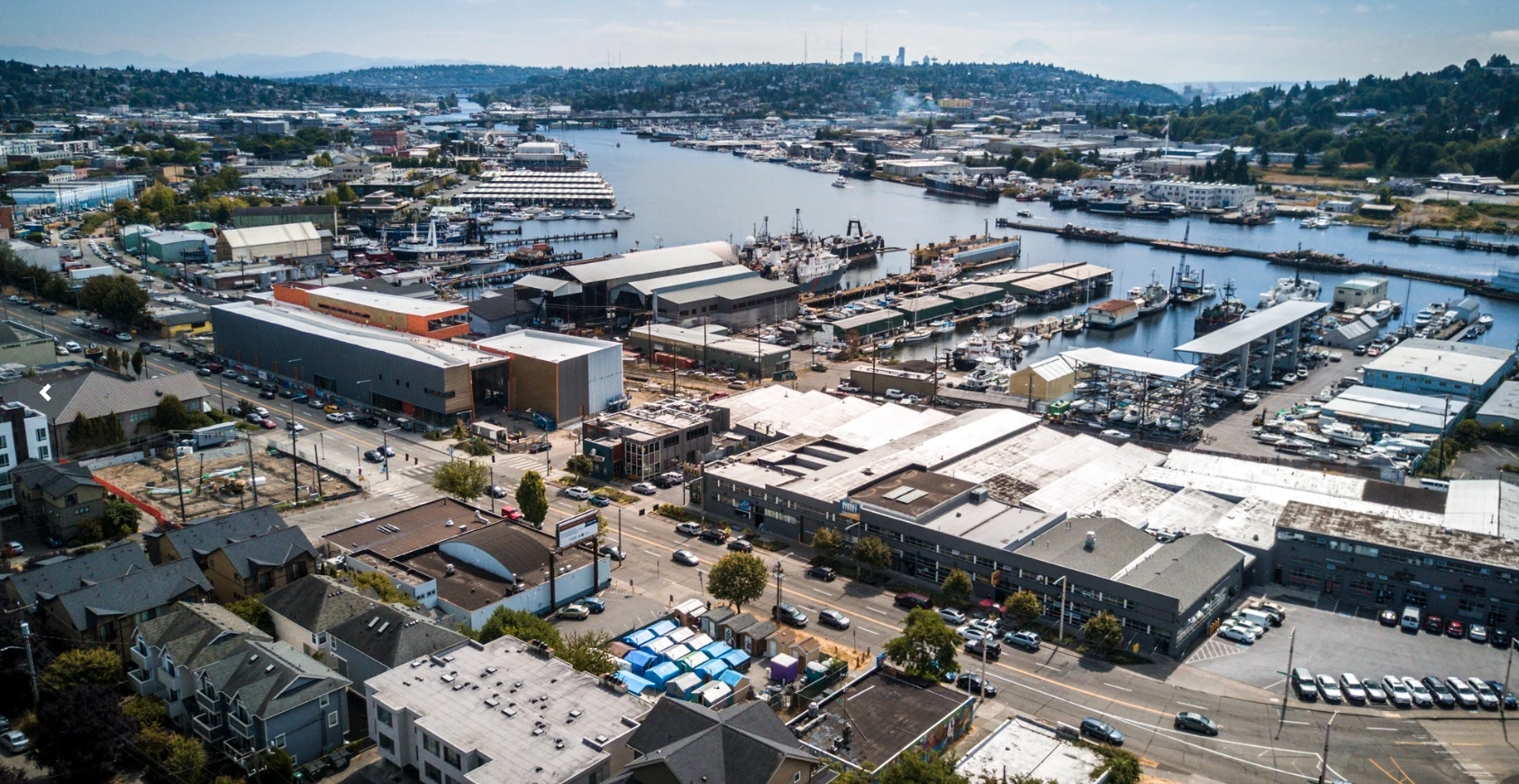 The blue roofs of a semi-sanctioned tent city can be seen in this aerial shot of Seattle