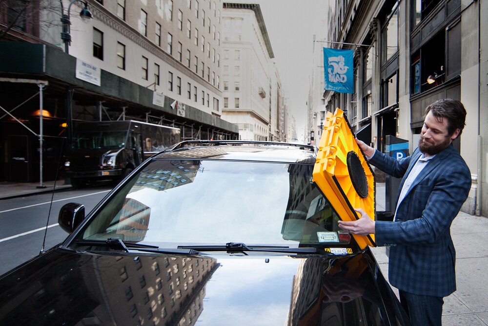 Parking officials need only lean across offending cars from the curb in order to install the Barnacle