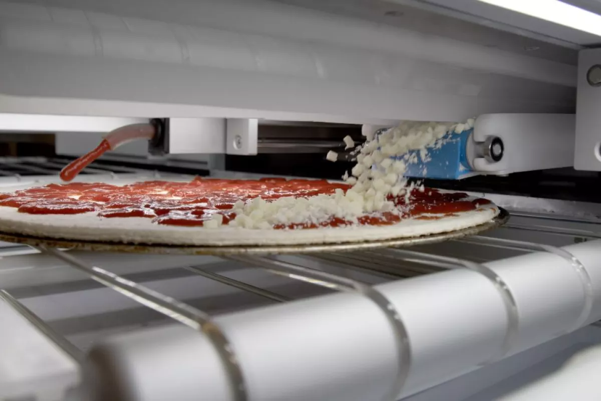 The food assembly system produces up to 300 pizzas an hou