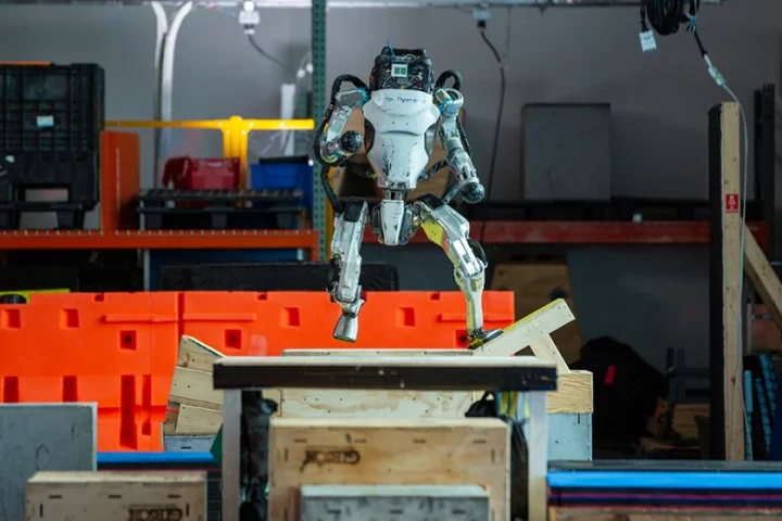 Atlas, a groundbreaking humanoid robot by Boston Dynamics, running across uneven surfaces