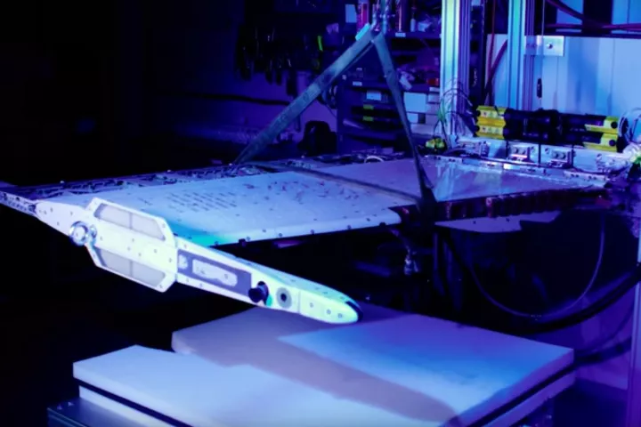 An F-18 wing section with a memory alloy actuator installed undergoing testing