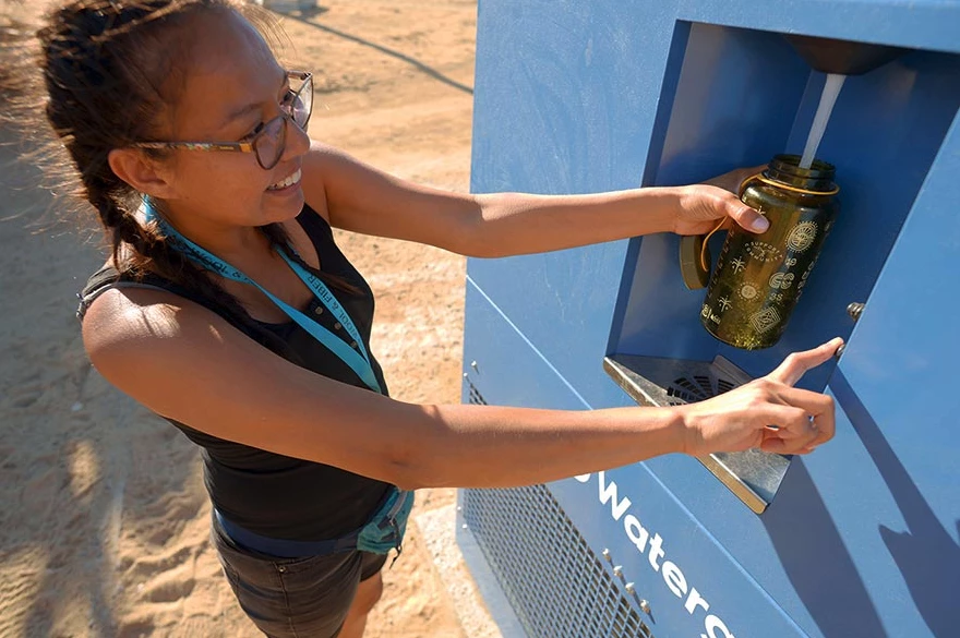 Pouring fresh water from the Watergen GEN-M in Arizona; this large unit supplies up to 211 gallons of fresh water a day