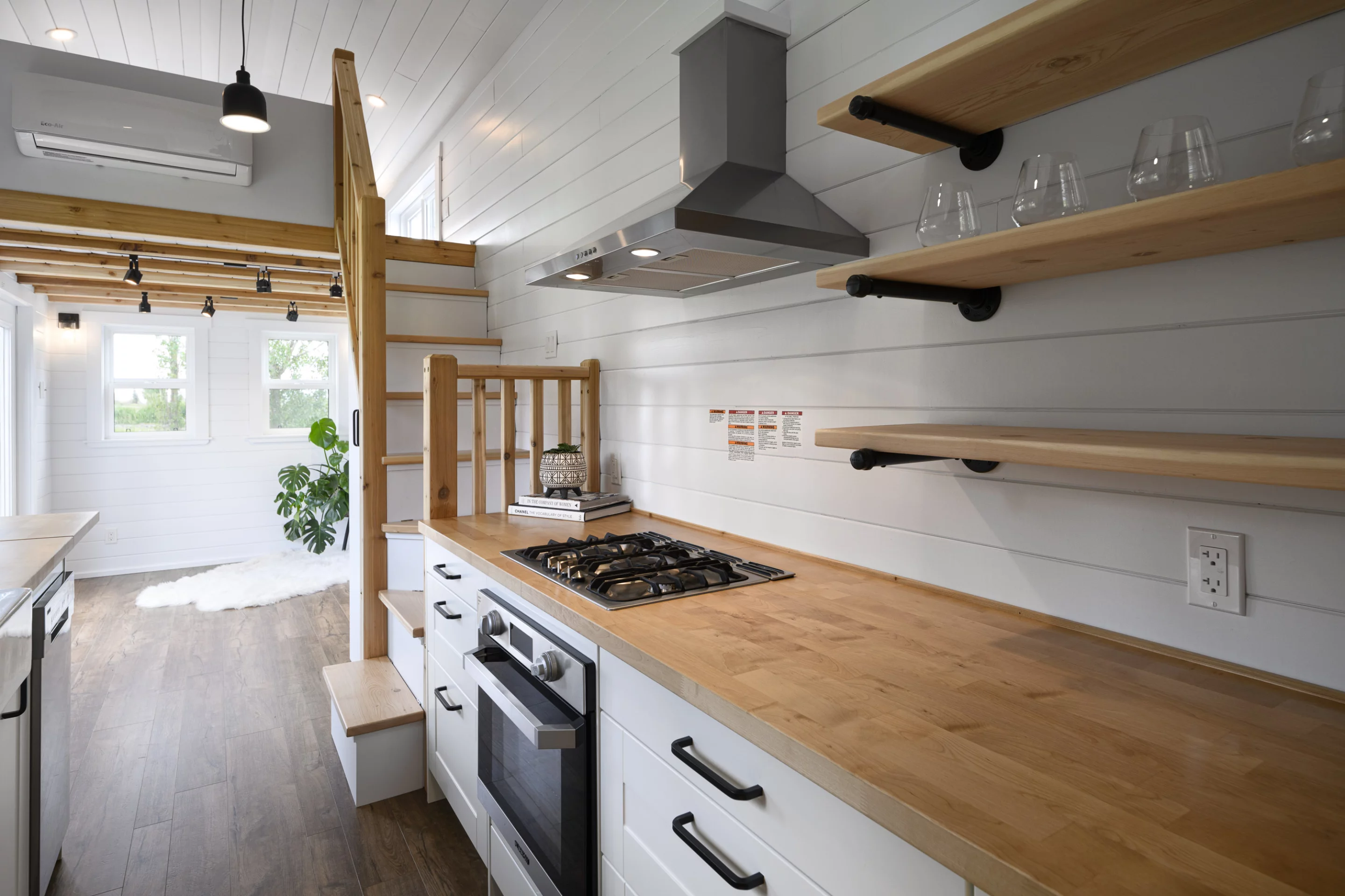 The Traveler's Paradise includes a spacious kitchen that has quite a lot of counter space and cabinetry for a tiny house