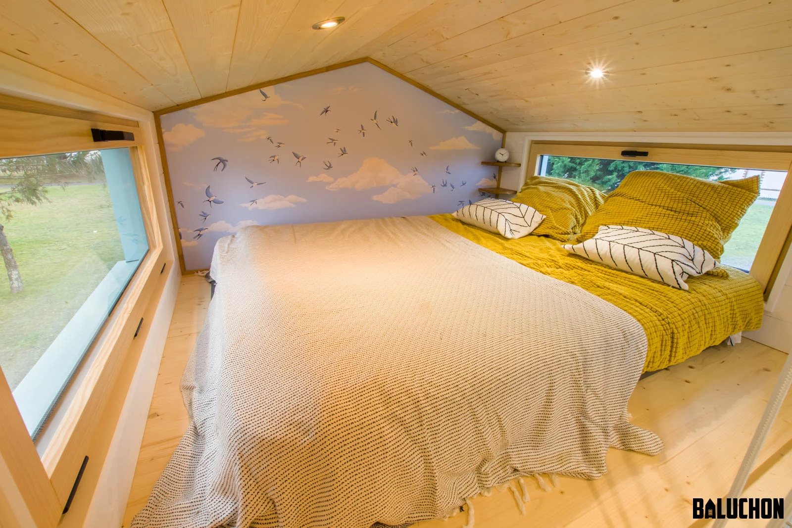 The Tiny house Kalzennig's main bedroom includes a double bed and has a typical tiny house-style low ceiling